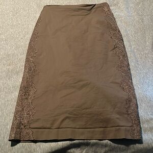 Brown pencil skirt with lace detail down the sides.